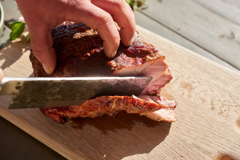 ￼Hands-cutting-Meat-from-BBQ￼-9217